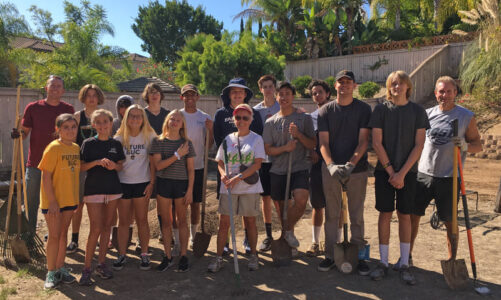 Volunteers clear yard of weeds and debris