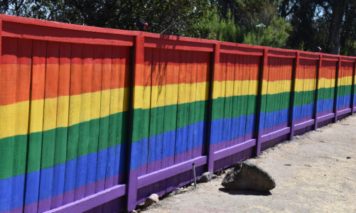 Volunteers repaint vandalized fence